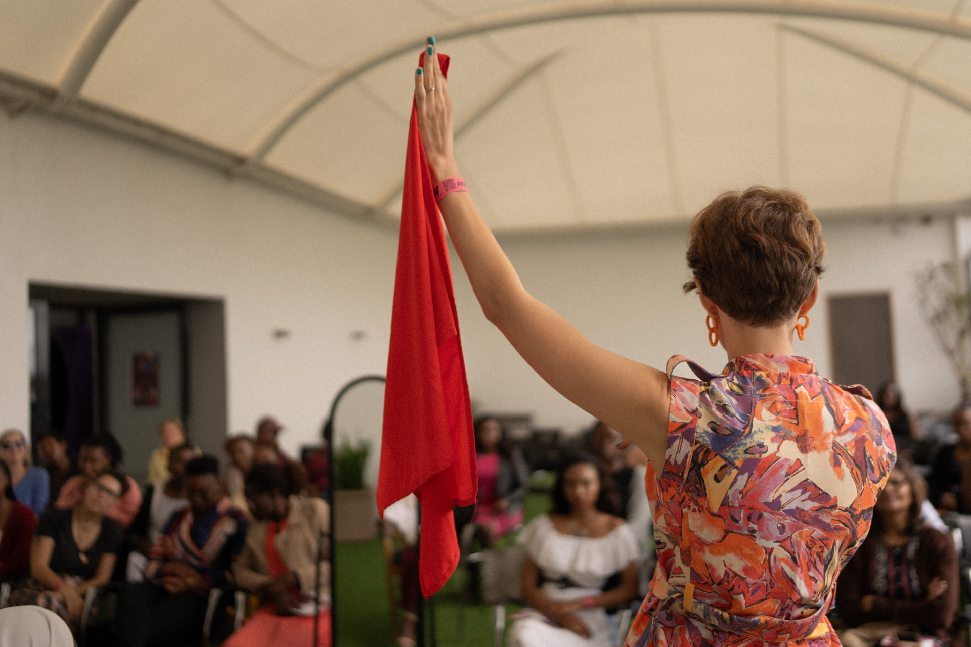 A client in a warm rust-coloured drape, photographed after a colour consultation